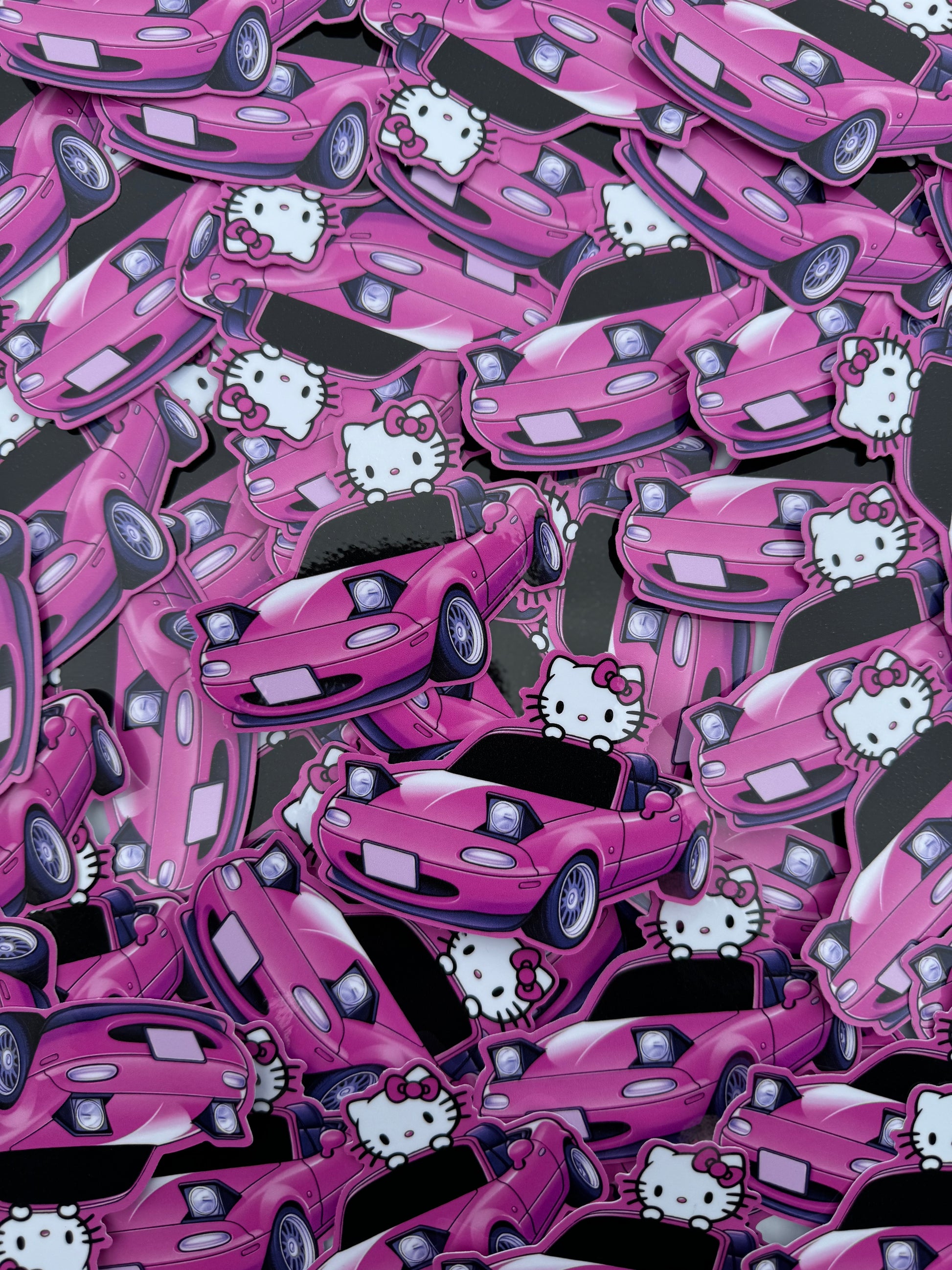 Sticker of a Pink Mazda Miata with Hello Kitty Driving